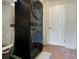 Laundry area with a stacked washer and dryer unit, along with a small rug at 1600 Dauphin Ln, Orlando, FL 32803
