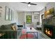 Living room featuring a fireplace, large windows with views, comfortable seating, and TV at 1600 Dauphin Ln, Orlando, FL 32803
