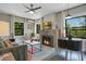 Cozy living room with a brick fireplace, large windows, comfortable seating and bright lighting at 1600 Dauphin Ln, Orlando, FL 32803