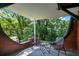 Outdoor patio with chairs, table, and beautiful, peaceful view of trees and shade at 1600 Dauphin Ln, Orlando, FL 32803