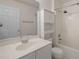 Bathroom featuring a white vanity with sink, toilet, and tiled shower/tub combo at 16243 Wilkinson Dr, Clermont, FL 34714
