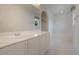 Bathroom featuring a white vanity with sink, tub, and large mirror at 16243 Wilkinson Dr, Clermont, FL 34714