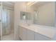 Bathroom featuring a white vanity with double sinks, tile floors, and walk-in shower at 16243 Wilkinson Dr, Clermont, FL 34714