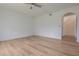 Bedroom with light wood floors, arched doorway, and ceiling fan at 16243 Wilkinson Dr, Clermont, FL 34714