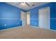 Bedroom with blue walls, white trim and carpet floors at 16243 Wilkinson Dr, Clermont, FL 34714