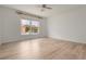 Bedroom with wood-look floors, large window and ceiling fan at 16243 Wilkinson Dr, Clermont, FL 34714