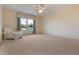 Bedroom featuring large window, carpet, and armchair at 16243 Wilkinson Dr, Clermont, FL 34714