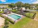 Community pool and playground offer outdoor fun, complemented by lounge chairs and lush greenery at 16243 Wilkinson Dr, Clermont, FL 34714