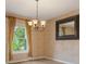 Charming dining room featuring wood-look floors, natural light, and decorative chandelier at 16243 Wilkinson Dr, Clermont, FL 34714