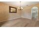 Charming dining room featuring wood-look floors, natural light, and decorative chandelier at 16243 Wilkinson Dr, Clermont, FL 34714