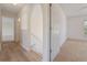 Hallway with arched doorways, wood floors, and access to bedrooms at 16243 Wilkinson Dr, Clermont, FL 34714