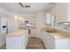 Bright kitchen with an island, stainless steel appliances, tile floors and modern lighting at 16243 Wilkinson Dr, Clermont, FL 34714