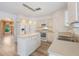 Bright kitchen with white cabinets, center island, and stainless steel appliances at 16243 Wilkinson Dr, Clermont, FL 34714