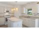 Bright kitchen with an island, stainless steel appliances, tile floors and modern lighting at 16243 Wilkinson Dr, Clermont, FL 34714