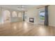 Bright living room with fireplace, new hardwood floors, arches and natural light from the windows at 16243 Wilkinson Dr, Clermont, FL 34714