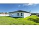 Home's backyard featuring a newly installed lawn, large windows, and a sliding glass door at 16252 Sw 27Th Terrace Rd, Ocala, FL 34473