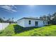 Home's backyard featuring a newly installed lawn, large windows, and a sliding glass door at 16252 Sw 27Th Terrace Rd, Ocala, FL 34473