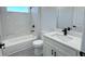 A modern bathroom featuring marble tiling, quartz countertops, and matte black hardware at 16252 Sw 27Th Terrace Rd, Ocala, FL 34473