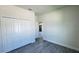 A cozy bedroom with gray wood floors and a closet at 16252 Sw 27Th Terrace Rd, Ocala, FL 34473