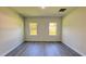 This room features two windows providing ample light and hardwood flooring at 16252 Sw 27Th Terrace Rd, Ocala, FL 34473