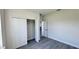 Bedroom features a closet with gray wood floors and natural light at 16252 Sw 27Th Terrace Rd, Ocala, FL 34473
