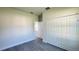 A cozy bedroom with gray wood floors and a closet at 16252 Sw 27Th Terrace Rd, Ocala, FL 34473
