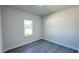 A modern bedroom with hardwood floors and bright natural light from the large window at 16252 Sw 27Th Terrace Rd, Ocala, FL 34473