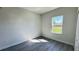 A modern bedroom with hard wood floors and a view of the yard through the window at 16252 Sw 27Th Terrace Rd, Ocala, FL 34473