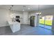 A bright kitchen with an island, modern appliances, and gray wood floors at 16252 Sw 27Th Terrace Rd, Ocala, FL 34473