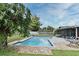 Relaxing backyard pool featuring brick trim, lush tropical plants, and outdoor furniture at 173 Tollgate Br, Longwood, FL 32750