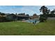 Backyard features a private pool, screened in patio, green grass, and lush landscaping at 173 Tollgate Br, Longwood, FL 32750