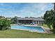 Backyard features a private pool, screened in patio, and green grass at 173 Tollgate Br, Longwood, FL 32750