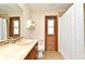 Bathroom with unique wood door, custom sink and tile backsplash, toilet, and shower curtain at 173 Tollgate Br, Longwood, FL 32750