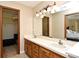 Bathroom boasts a double vanity, a large mirror, and access to the walk-in closet at 173 Tollgate Br, Longwood, FL 32750