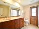 Bathroom with dual sinks, large mirror, and neutral colors at 173 Tollgate Br, Longwood, FL 32750