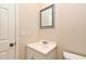 Bathroom showcasing a vanity with sink and mirror, alongside a toilet and a door at 173 Tollgate Br, Longwood, FL 32750