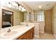 Bathroom with a double sink vanity, a mirror, and a glass block window at 173 Tollgate Br, Longwood, FL 32750
