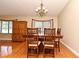 Dining room offers hardwood floors, a stylish chandelier, and a large dining table with seating for six at 173 Tollgate Br, Longwood, FL 32750