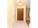 Welcoming foyer with tile flooring, a wood front door, and a white interior door at 173 Tollgate Br, Longwood, FL 32750