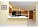 Kitchen featuring wooden cabinetry, white countertops, and black appliances at 173 Tollgate Br, Longwood, FL 32750