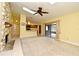 Bright living room with tile and carpet, stone fireplace, and access to kitchen and lanai at 173 Tollgate Br, Longwood, FL 32750