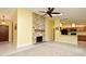 Open-concept living room showcasing a stone fireplace and a view of the kitchen and front entry at 173 Tollgate Br, Longwood, FL 32750