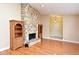 Spacious living room showcasing hardwood floors, a stone fireplace, and built-in shelving for added storage at 173 Tollgate Br, Longwood, FL 32750