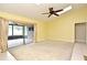 Open and airy living room leading to a screened lanai, featuring neutral walls and ceiling fan at 173 Tollgate Br, Longwood, FL 32750