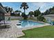 Backyard pool with brick trim, outdoor furniture, and well-maintained lawn at 173 Tollgate Br, Longwood, FL 32750