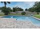 Backyard pool with brick trim, outdoor furniture, and well-maintained lawn at 173 Tollgate Br, Longwood, FL 32750