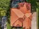 This is an aerial view of a red tiled roof, screened-in pool, and surrounding foliage at 1813 Glenbay Ct, Windermere, FL 34786