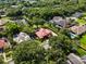 Aerial view of a luxurious home with a terracotta roof, landscaped yard, and neighborhood pool for ultimate living experience at 1813 Glenbay Ct, Windermere, FL 34786