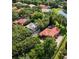 Aerial view of community homes with mature trees and a pond at 1813 Glenbay Ct, Windermere, FL 34786
