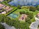 Aerial view showcasing community amenities, including a basketball court and playground, with a serene lake in the background at 1813 Glenbay Ct, Windermere, FL 34786